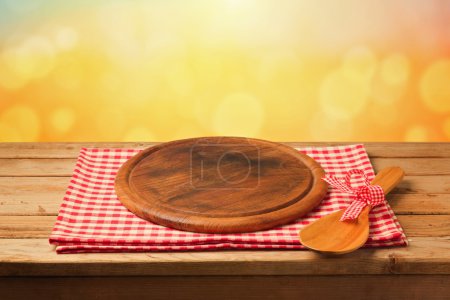 Round board on tablecloth on table