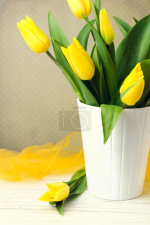 Yellow tulip bouquet over vintage background