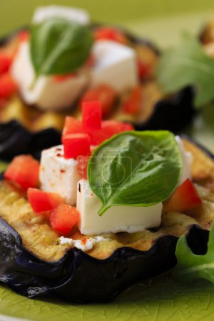 Grilled eggplant with feta cheese, red peppers and basil 