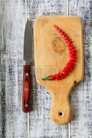 Fresh chili peppers on wooden board