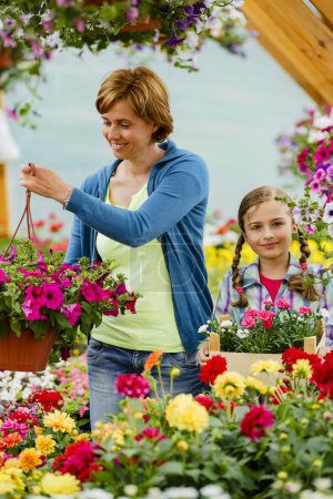 Planting, garden flowers - family shopping plants and flowers in garden center