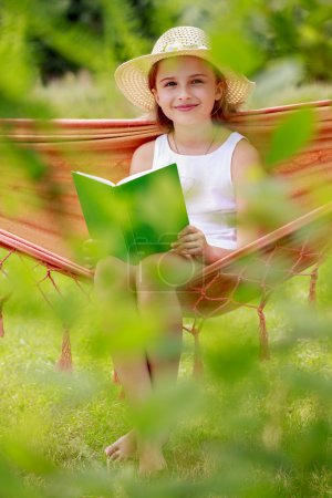 Summer joy, hammock - girl with a book resting on a hammock
