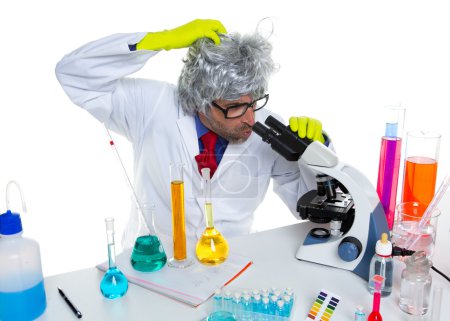 Crazy mad nerd scientist at laboratory microscope
