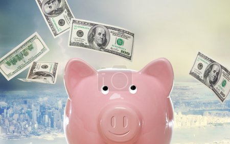 Piggy bank with hundred dollar bills