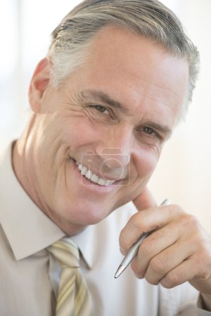 Close-Up Of Businessman Smiling In Office