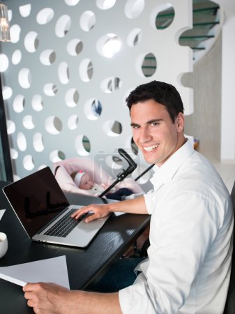 man working from home and take care of baby