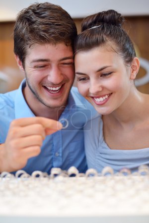 happy young couple in jewelry store
