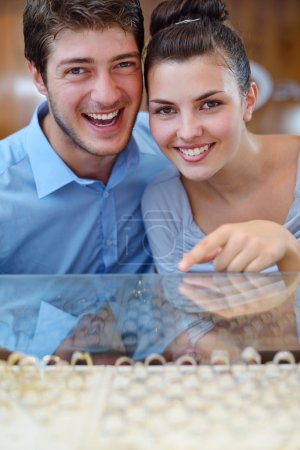 happy young couple in jewelry store