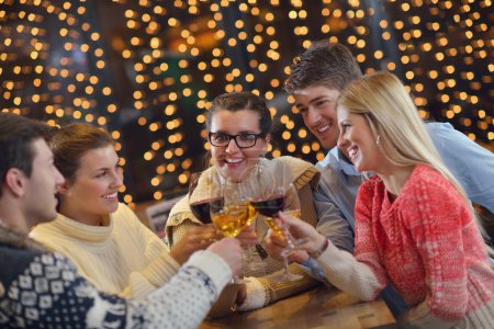 Group of happy young drink wine at party