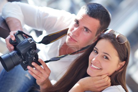 Couple looking photos on camera
