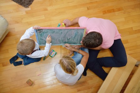 Family drawing on school board at home