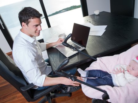 man working from home and take care of baby