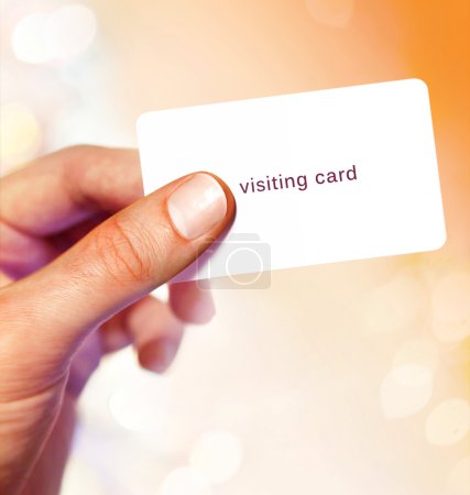 White visit card in hand