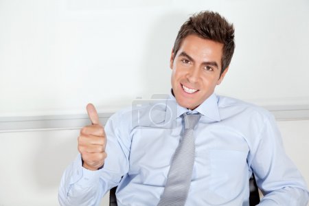 Young Businessman Gesturing Thumbs Up