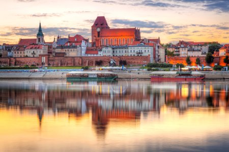 Torun old town reflected in Vistula river at sunset