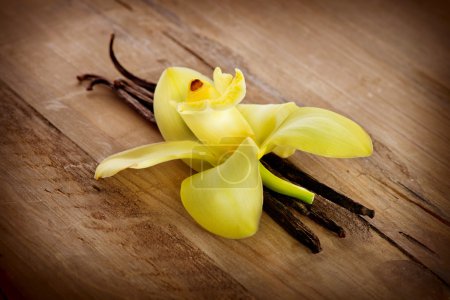 Vanilla Pods And Flower on a Wooden Background