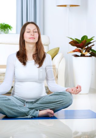 Beautiful Pregnant Woman Doing Yoga at Home