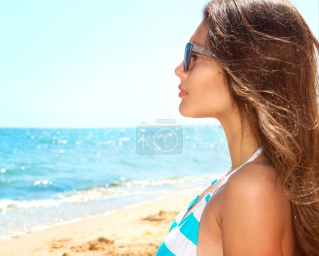 Girl Wearing Sunglasses over Ocean.