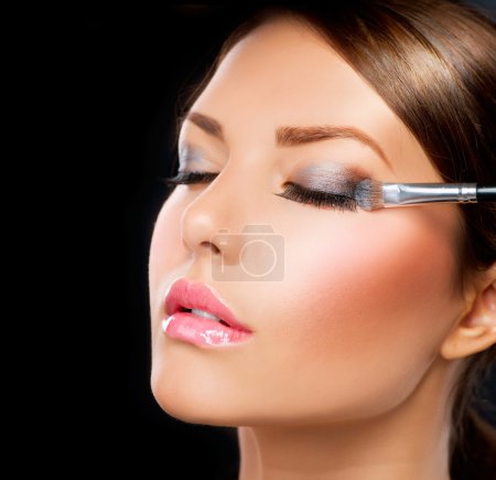 Make-up applying. Eye shadow brush