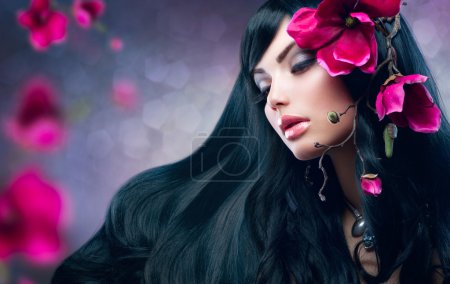 Beauty Brunette Model Girl with Big Purple Flowers in her Hair
