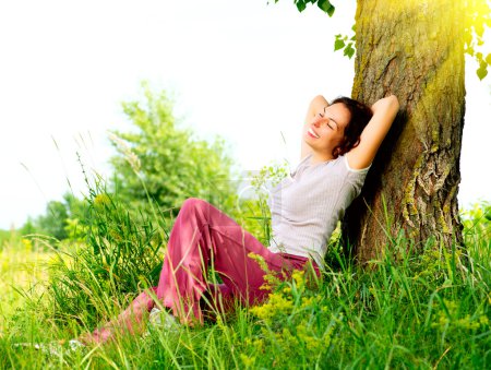 Beautiful Young Woman Relaxing outdoors. Nature