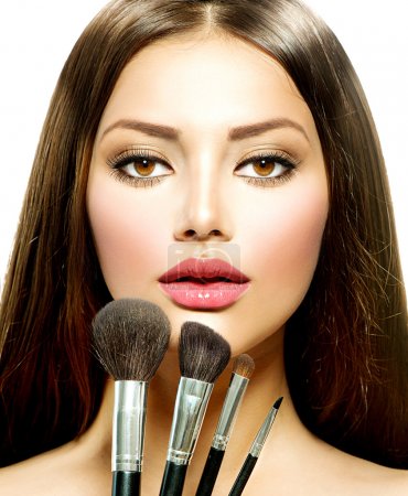 Beauty Girl with Makeup Brushes. Make-up for Brunette Woman