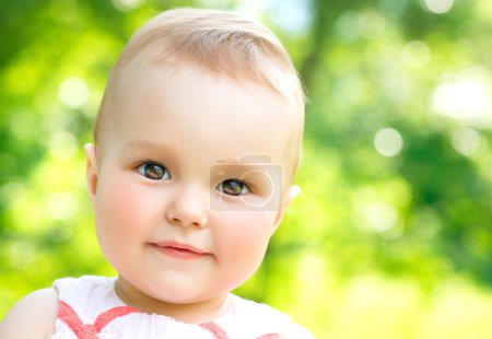 Little Baby Girl Portrait outdoor. Child over nature background