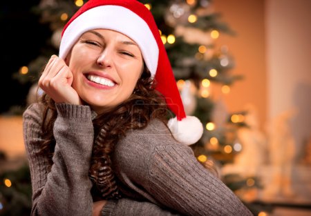 Christmas Woman in Santa Hat. Happy Smiling Girl
