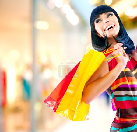 Beauty Woman with Shopping Bags in Shopping Mall