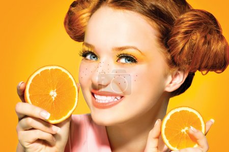 Model girl with juicy oranges.