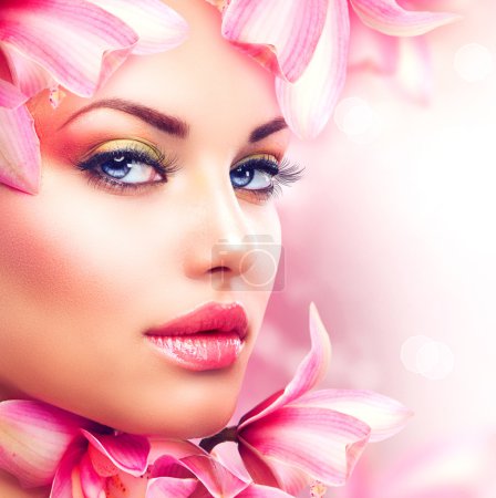 Beautiful Girl With Orchid Flowers. Beauty Woman Face