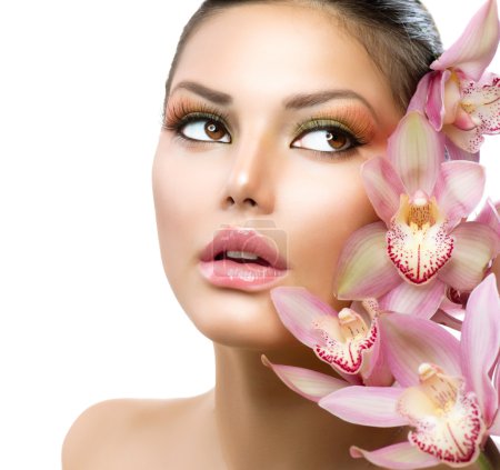 Beautiful Girl With Orchid Flowers. Beauty Model Woman Face