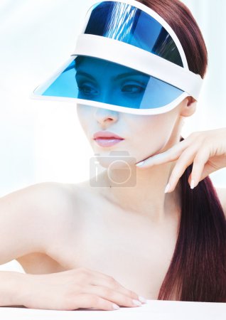 Portrait of attractive young adult woman with sun visor