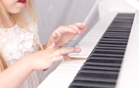 Child playing on piano