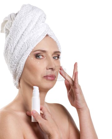 woman applying cream for face