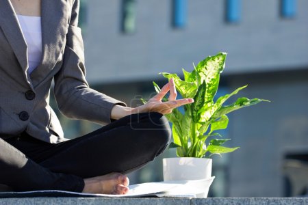 meditating businesswoman and flower