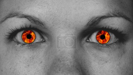 Detail view of female eyes with flames
