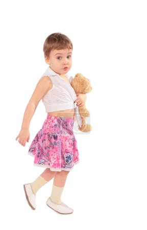 Little girl in skirt with toy