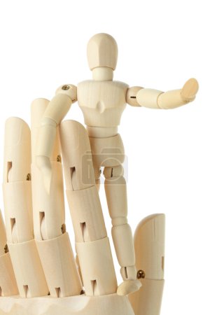Wooden figure of little man standing on big hand and pointing at