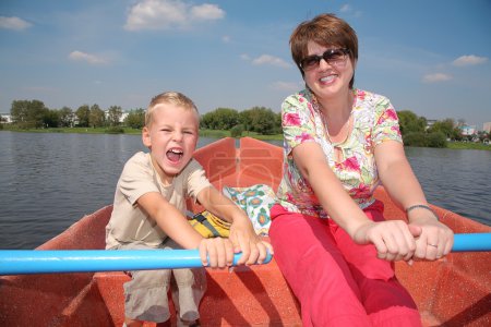 Woman and boy in the boat with the oars 2
