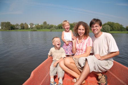 Family with the children in the boat