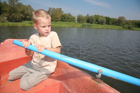 Boy in the boat with the oar