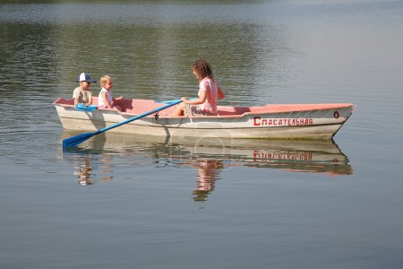 Mother with the children in the boat