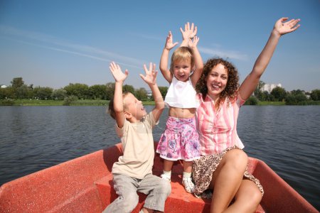 Merry mother with the children in the boat