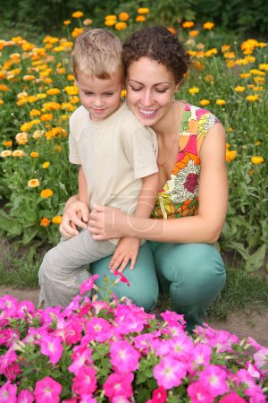 Mother and son look on flowers