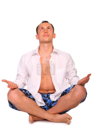 Man sitting in pose of lotus