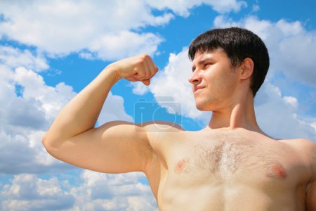 Bodybuilder on sky background