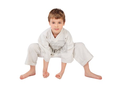 Karateka boy in white kimono isolated on white background
