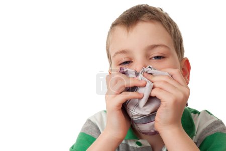 Chilled boy wipes scarf nose isolated on white background