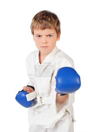 Little boxer boy in white dress and blue boxing gloves fighting